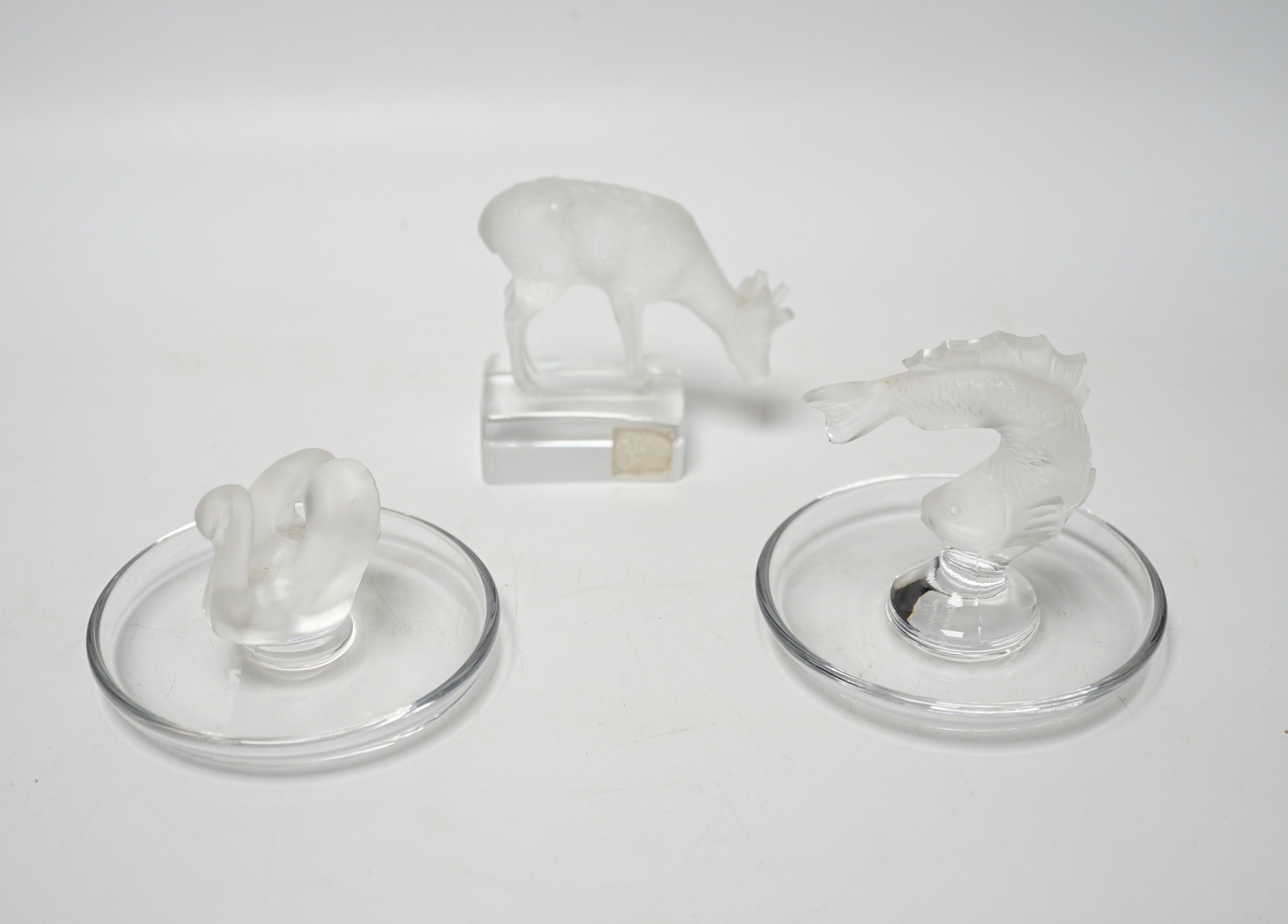 Rene Lalique - two glass pin dishes modelled as a swan and a fish together with a paperweight modelled as a giraffe, signed ‘Lalique France’ to base, tallest 9.5cm high (3)